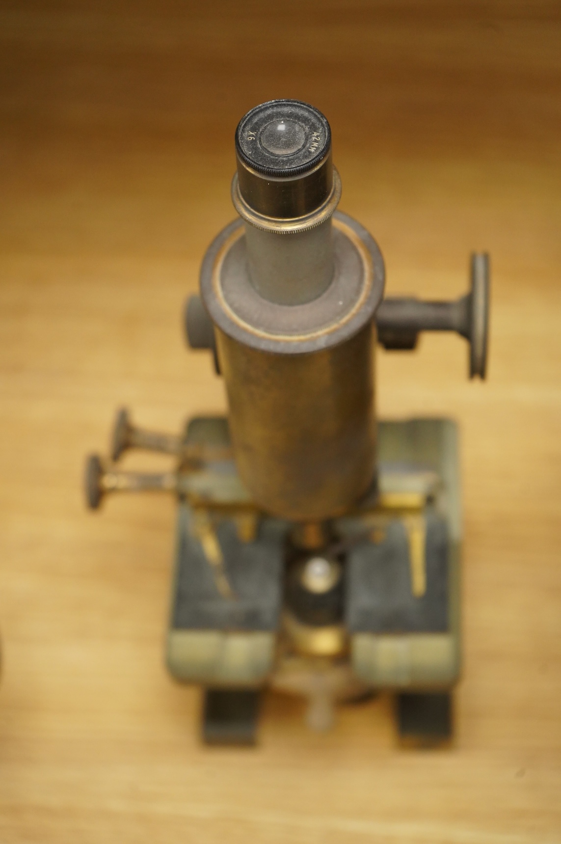 An early 20th century brass compound monocular microscope, by R & J Beck, Ltd., London, number 33007, with accessories including spare lenses, a free standing magnifier and objectives, mahogany cased; 34.5cm high, 19cm w